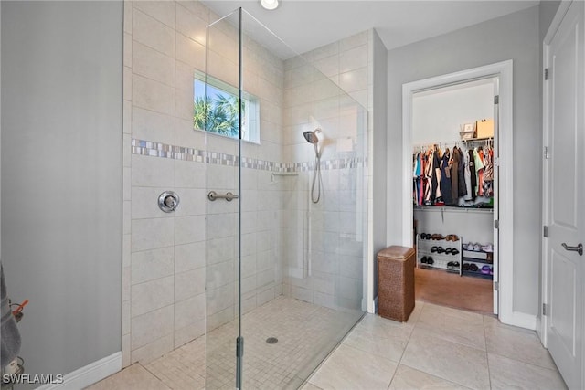 bathroom with tile patterned floors and a tile shower