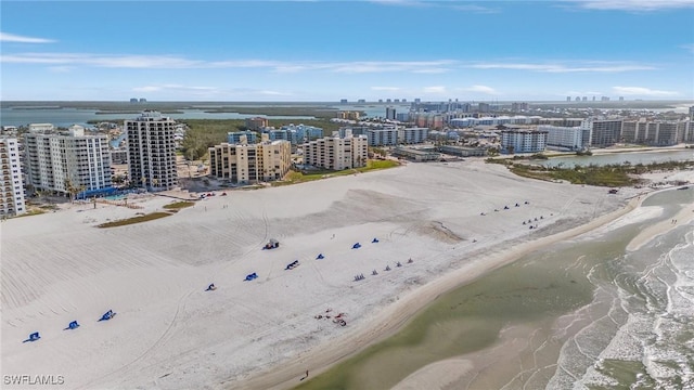 birds eye view of property featuring a water view and a view of the beach