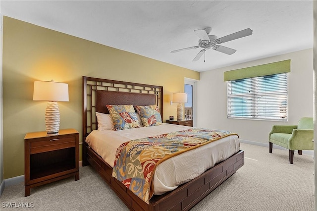 bedroom with ceiling fan and light colored carpet