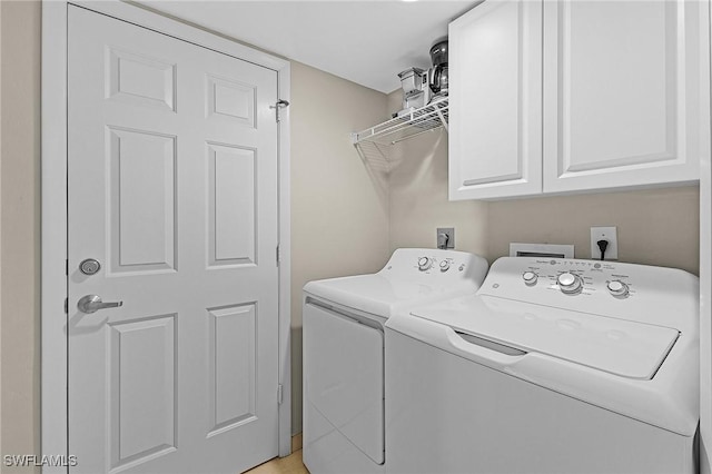 laundry area featuring cabinets and washer and clothes dryer