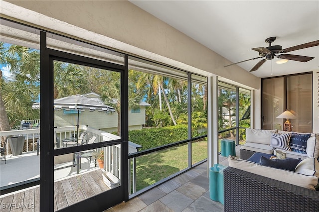 sunroom / solarium with a wealth of natural light, ceiling fan, and lofted ceiling