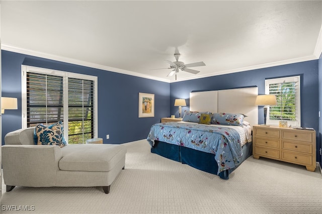 carpeted bedroom with ceiling fan and ornamental molding