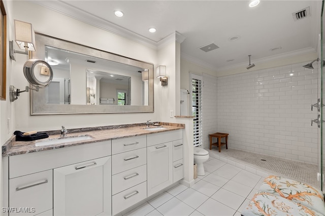 bathroom featuring tile patterned floors, vanity, tiled shower, and ornamental molding