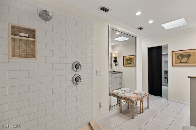 bathroom featuring a skylight, tile patterned floors, vanity, crown molding, and tiled shower