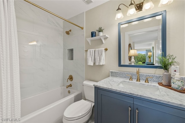 bathroom featuring visible vents, vanity, toilet, and shower / bath combo with shower curtain