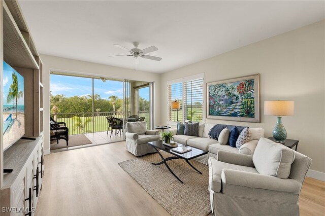 living room featuring ceiling fan and light wood-type flooring