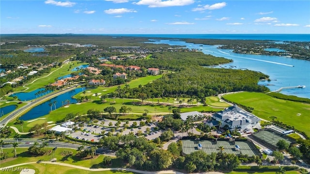 drone / aerial view with a water view and golf course view