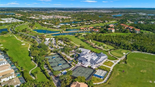 birds eye view of property with view of golf course, a water view, and a residential view