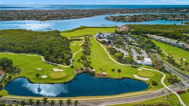 drone / aerial view featuring view of golf course and a water view