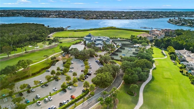 birds eye view of property with a water view and golf course view