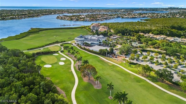 drone / aerial view featuring view of golf course and a water view