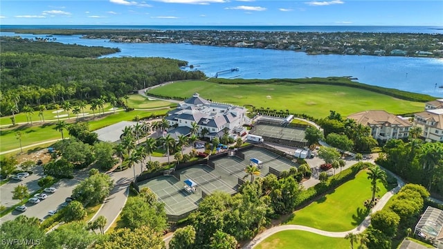 drone / aerial view featuring golf course view and a water view