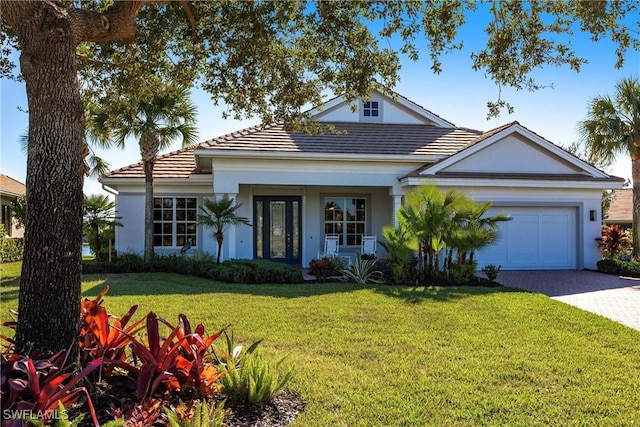 view of front of property featuring a garage and a front lawn