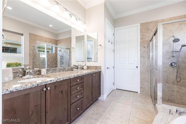 bathroom with tile patterned floors, vanity, an enclosed shower, and crown molding