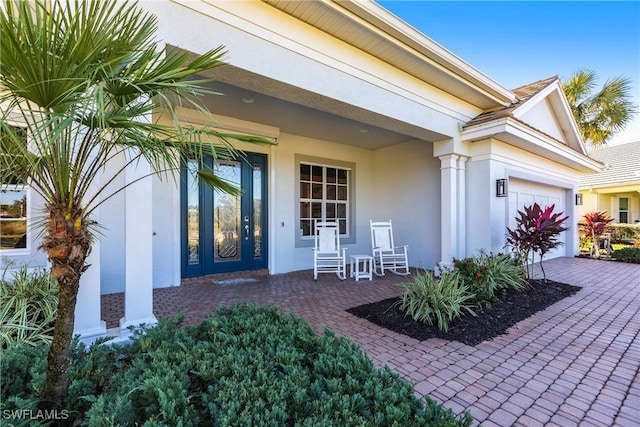 property entrance with a porch and a garage