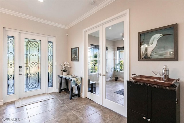 tiled foyer featuring french doors and crown molding