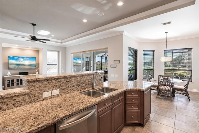 kitchen with light stone countertops, stainless steel dishwasher, ceiling fan, sink, and pendant lighting