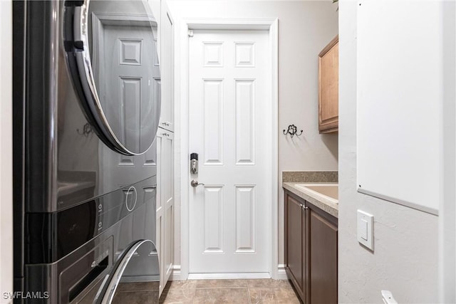 laundry area featuring cabinets and light tile patterned floors