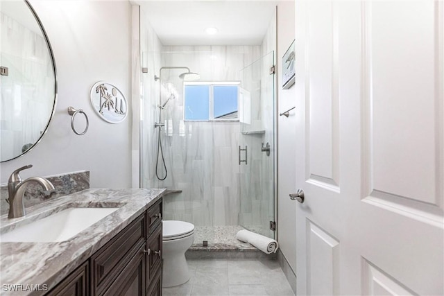 bathroom with vanity, toilet, and an enclosed shower