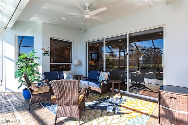 sunroom / solarium featuring ceiling fan