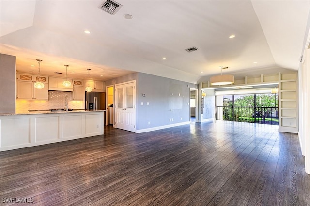 unfurnished living room with vaulted ceiling and dark wood-type flooring