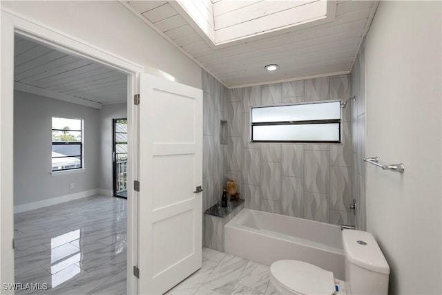 full bathroom with shower / bath combination, marble finish floor, baseboards, and toilet