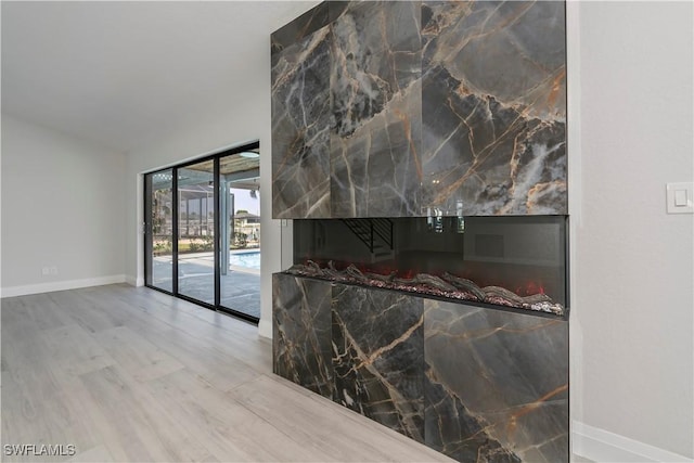 interior space featuring baseboards and wood finished floors