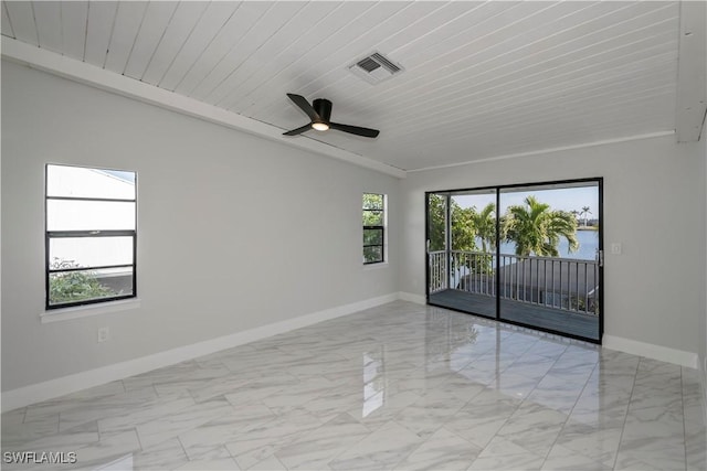 spare room with a ceiling fan, marble finish floor, visible vents, and baseboards