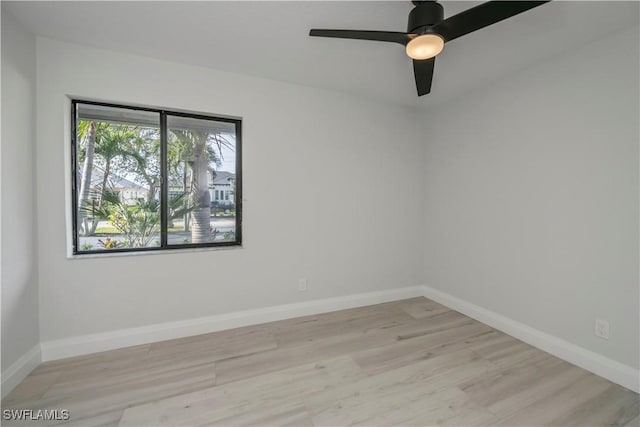 unfurnished room featuring light wood-style floors, ceiling fan, and baseboards