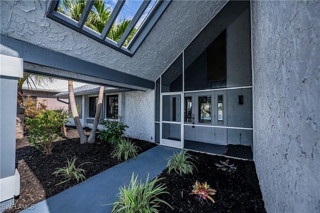 entrance to property with stucco siding