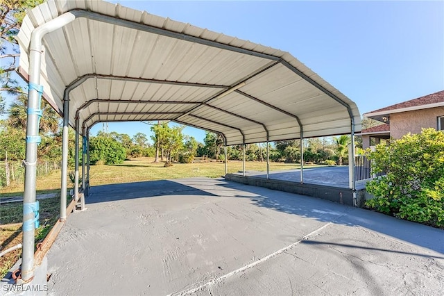 view of vehicle parking featuring a carport and a lawn