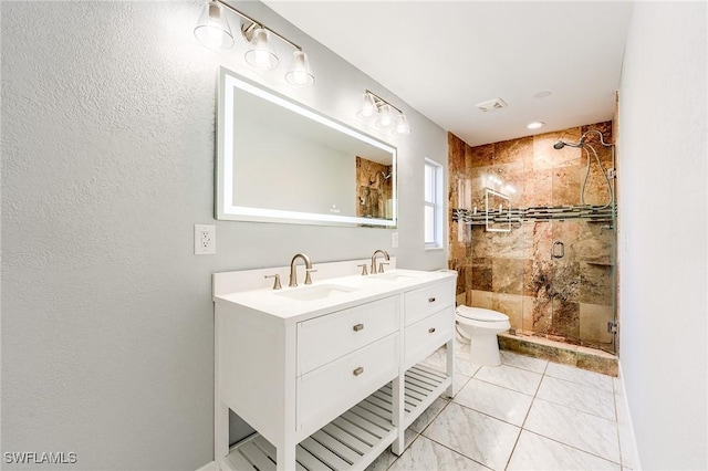 bathroom featuring toilet, vanity, and walk in shower