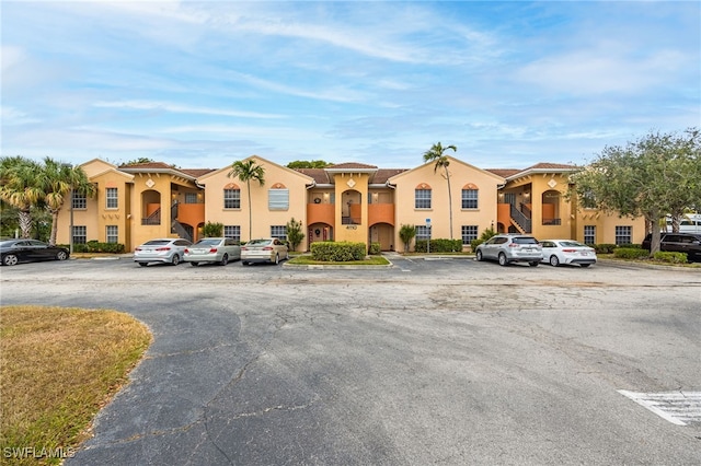 view of front of property featuring uncovered parking and stucco siding