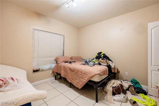 bedroom with light tile patterned floors