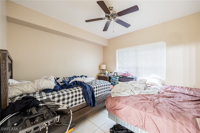 tiled bedroom with ceiling fan