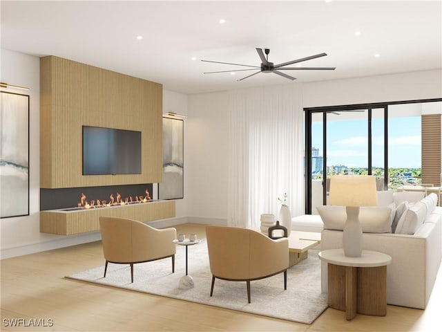 living room featuring a ceiling fan, baseboards, light wood finished floors, and recessed lighting