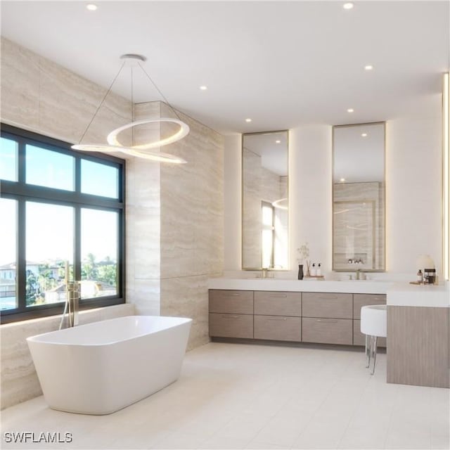 full bath featuring a freestanding tub, vanity, recessed lighting, walk in shower, and tile walls