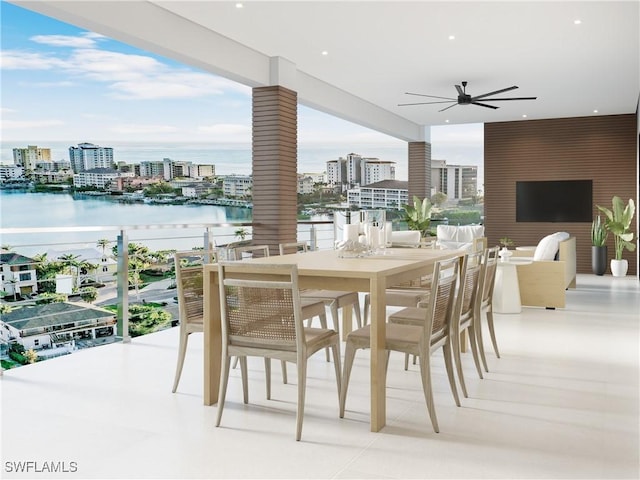exterior space with a balcony, ceiling fan, outdoor dining area, and a city view