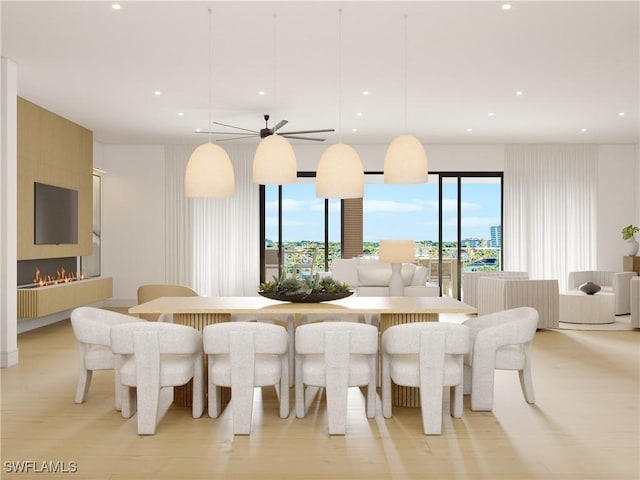 dining room featuring plenty of natural light, a fireplace, and recessed lighting