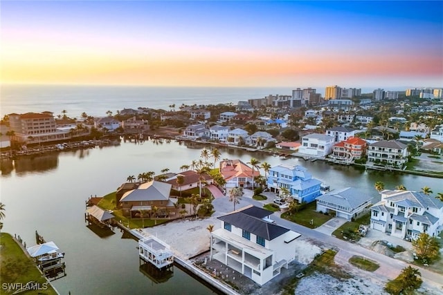 aerial view at dusk with a water view