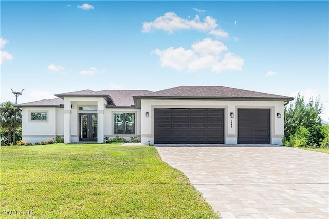 prairie-style home with french doors, a front lawn, and a garage