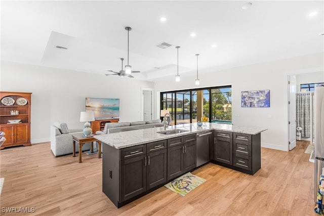 kitchen featuring ceiling fan, light stone counters, sink, and dishwasher