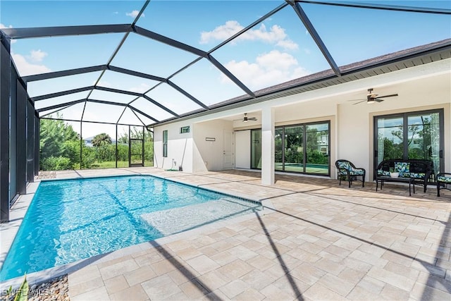 view of swimming pool with ceiling fan, a patio area, and a lanai