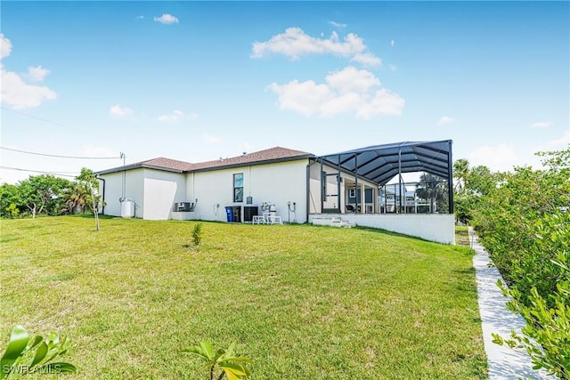 back of house with a lawn and glass enclosure