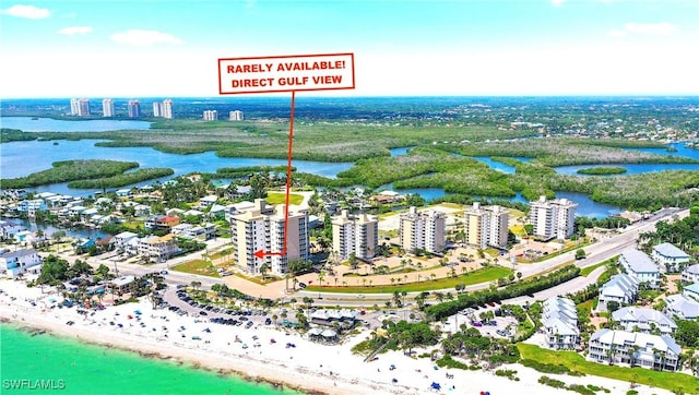 drone / aerial view with a water view and a view of the beach