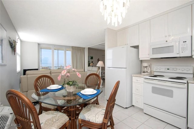 dining space with light tile patterned floors and a notable chandelier