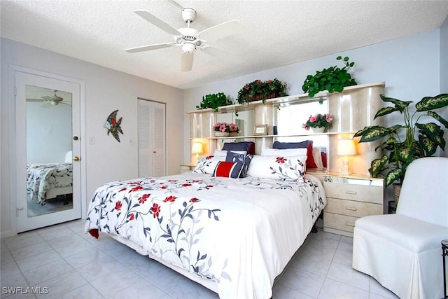 bedroom with a textured ceiling, a closet, and ceiling fan