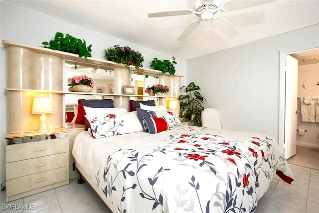 tiled bedroom featuring connected bathroom, ceiling fan, and a textured ceiling