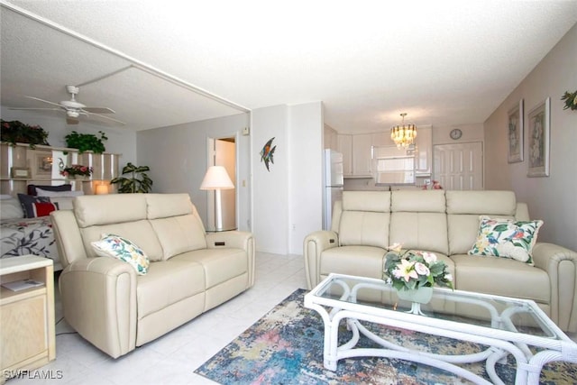 living room with ceiling fan with notable chandelier