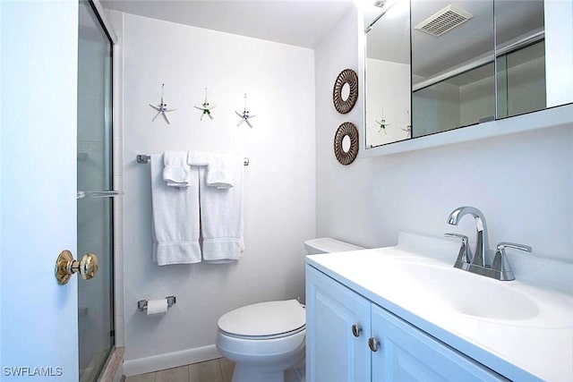 bathroom with vanity, an enclosed shower, and toilet